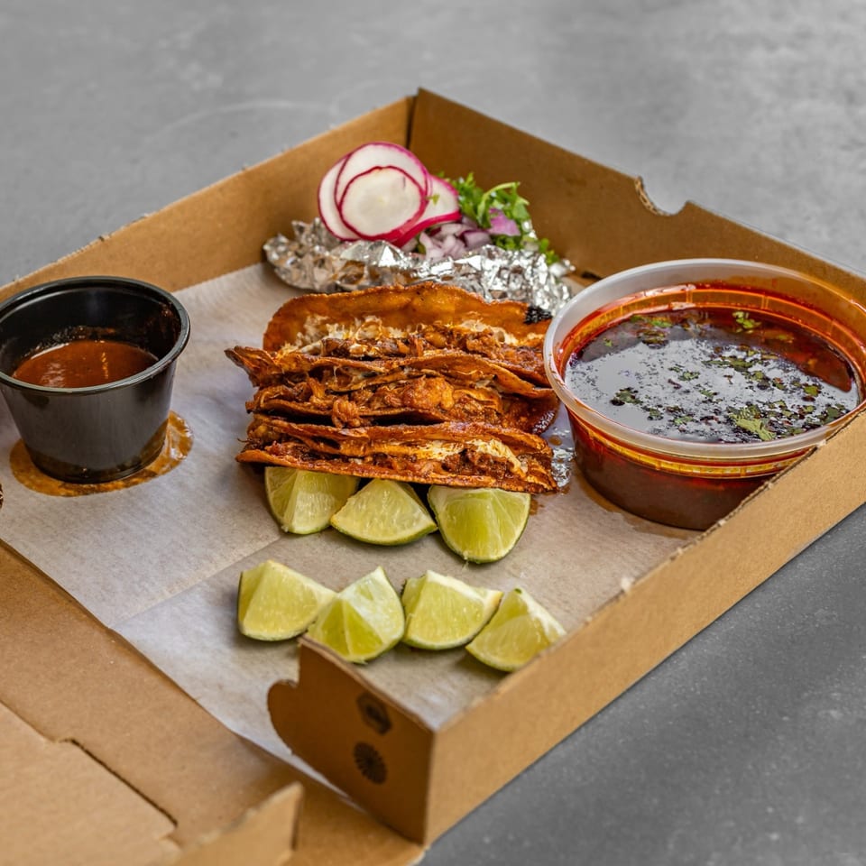 Crisp tacos served with consommé, salsa and lime wedges.